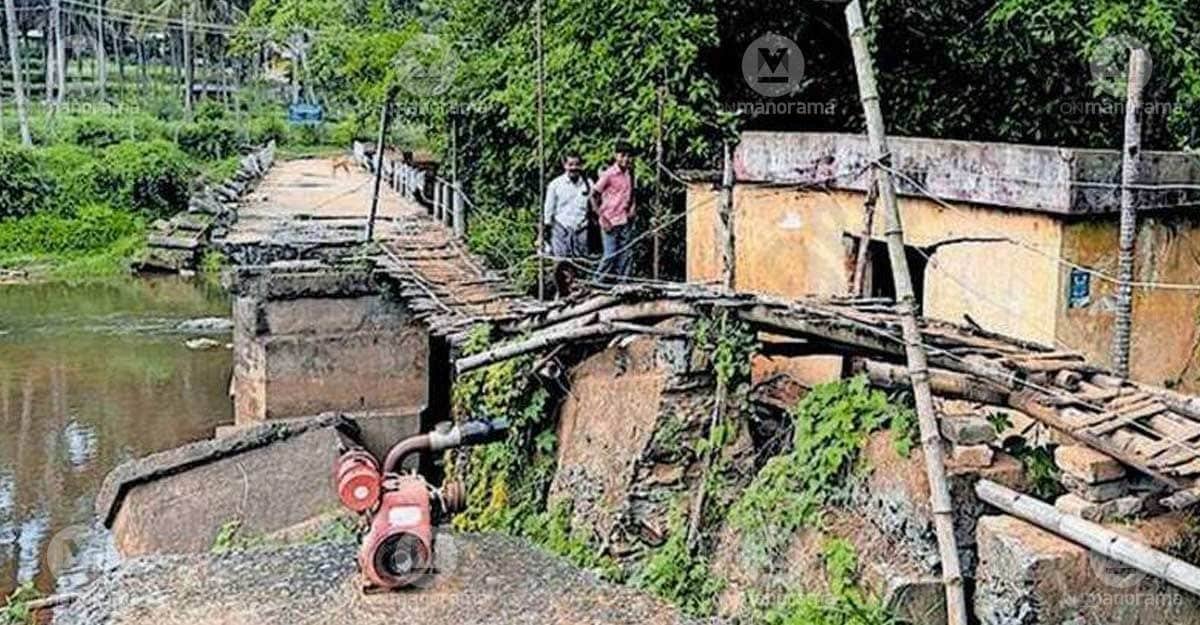 A student and parent crossing the damaged Sambarcode bridge towards Agali. Photo: Special arrangement