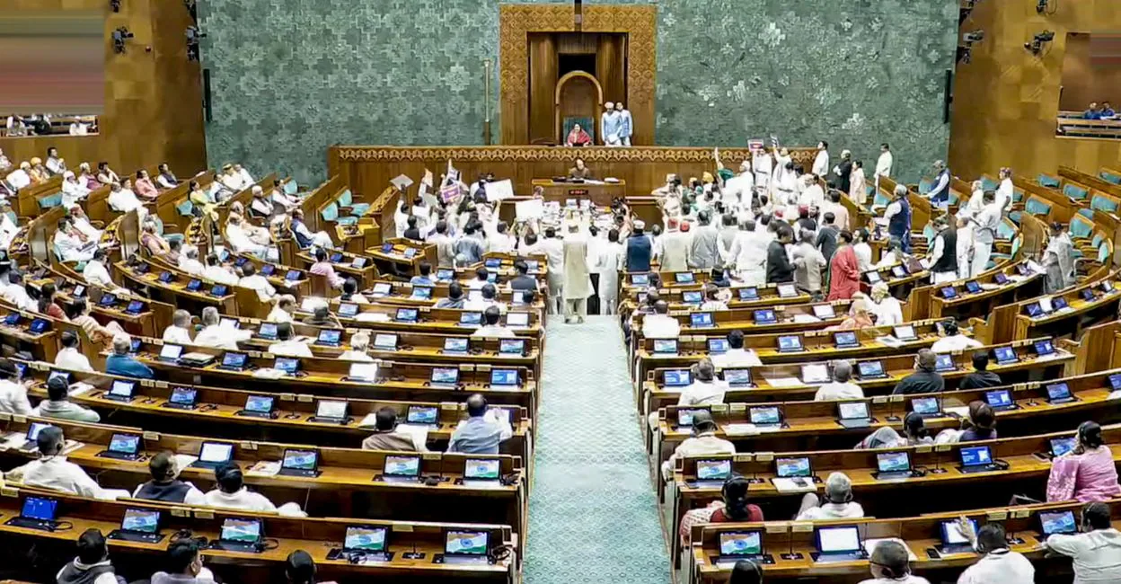 Opposition members protesting inside the Lok Sabha. Photo: PTI