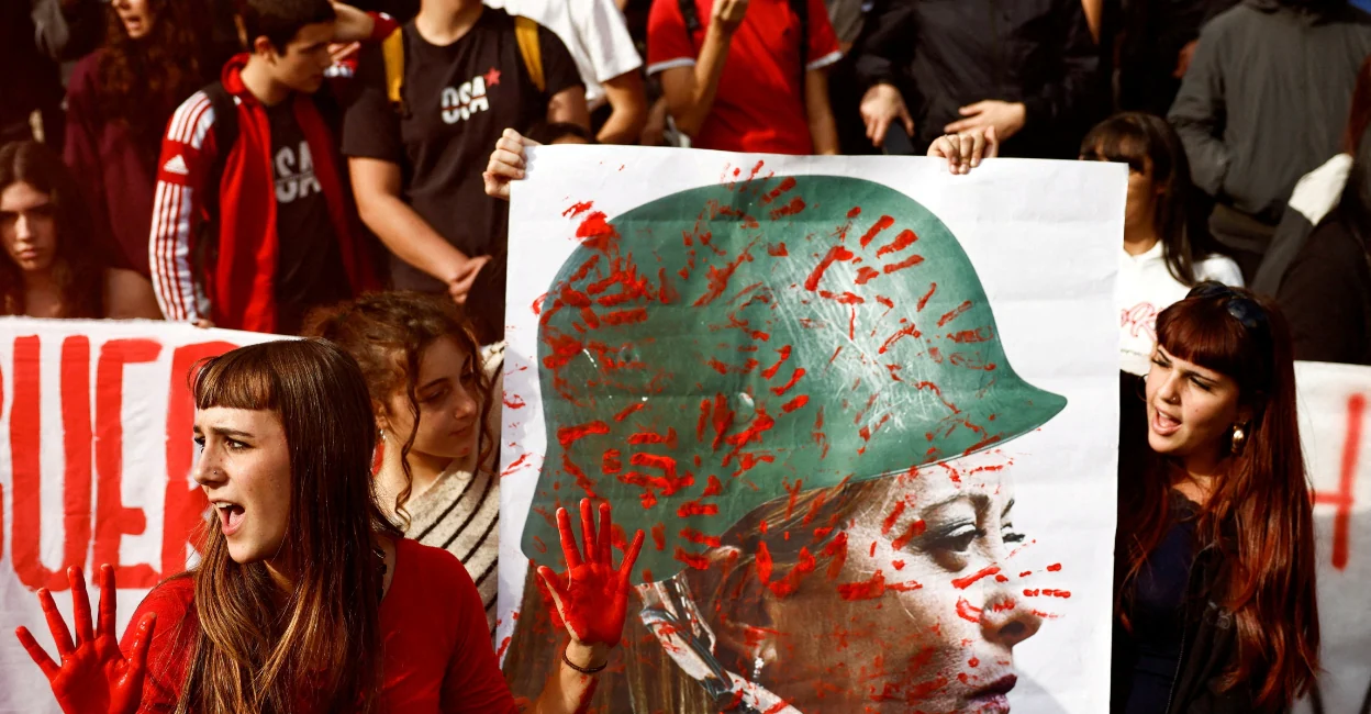 A file photo of a youngsters with a banner depicting Italy Prime Minister Giorgia Meloni during a 'No-Meloni Day' rally in Rome in November 2025. Photo: Reuters