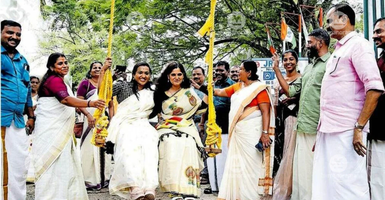 Deputy Mayor G S Ashanath and Collector Anu Kumari enjoy a swing ride during the Onam celebrations at the corporation office. Mayor V V Rajesh, councillors and employees look on. Photo: Special Arrangement.